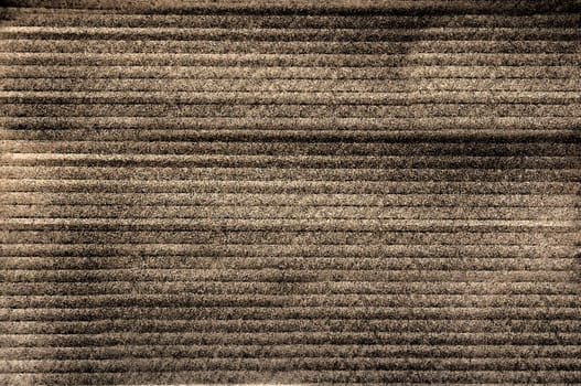 An old convex longitudinally horizontal pattern of a grunge brown textile background