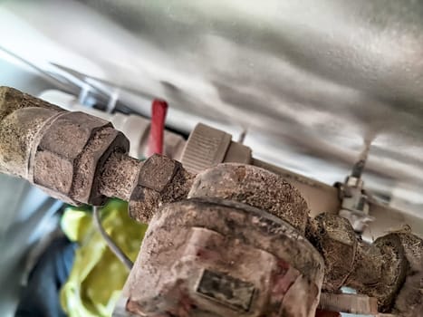 Dusty, old pipes visible in a maintenance area reflect years of wear and lack of upkeep along with potential plumbing issues.