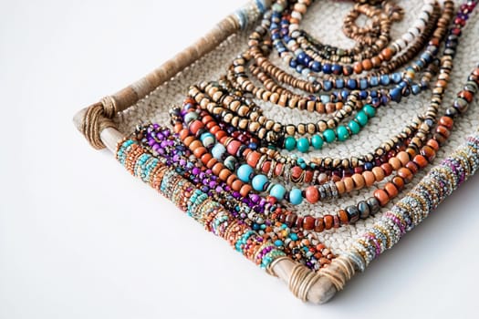 Various handcrafted beads are neatly organized on a woven tray in a creative workspace.