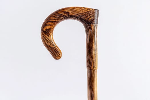 A beautifully crafted wooden walking cane shows off its elegant hook design and rich texture.