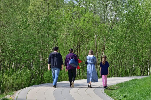 Family walking in the summer park, Russia