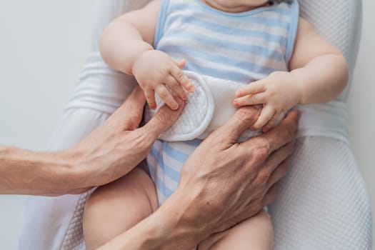 Adorable 3-month-old baby lying safely in a cozy infant cocoon secured with a special safety belt. Comfortable and protective design for newborn care. Parenting, safety, and baby comfort concept.