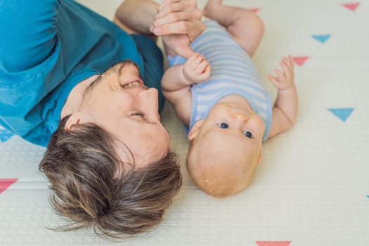 A loving father lies next to his 3-month-old baby, safely secured in a cozy infant cocoon with a special safety belt. Heartwarming family bonding moment. Parenthood, love, and baby care concept.