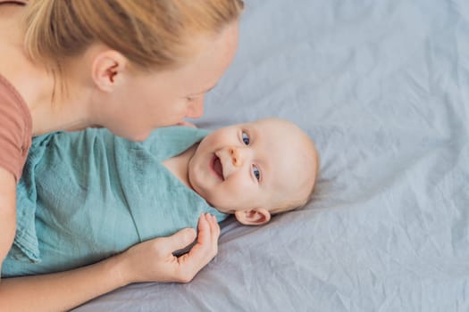 A mother gently wraps her baby in a soft muslin swaddle, providing warmth and comfort. A tender moment of care and love between mother and child. Motherhood, baby care, and nurturing concept