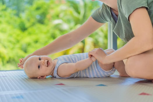 A mother practices baby gymnastics with her 3-month-old on a soft children's play mat. A joyful and nurturing moment focused on bonding, development, and care. Early childhood, fitness, and parenting concept.