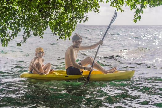 Father and son tourists kayaking on Bacalar Lake in Mexico. Adventure tourism in Quintana Roo, outdoor exploration, and water activities concept.