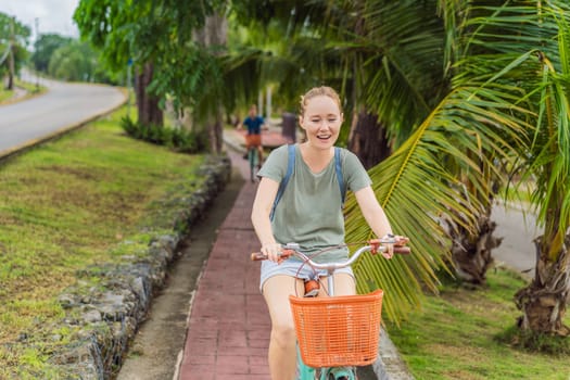 Female tourist cycling through the charming village of Bacalar, Mexico. Quintana Roo travel, scenic bike paths, and eco-friendly exploration concept.