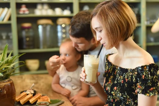 Young family eating waffles in a cafe