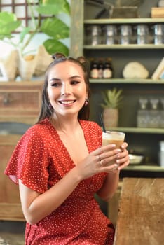 Young woman  drinking ice coffee in a coffee shop