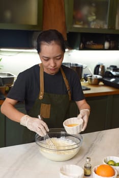 Young Vietnamese woman mixing