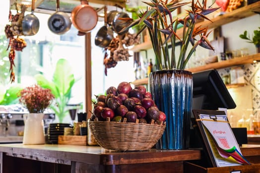 Loft design of interior with passion fruits and decor near cashier counter and menu