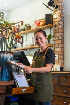 Vietnamese happy waitress working in a kitchen of a cafe