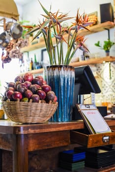 Loft design of interior with passion fruits and decor near cashier counter and menu