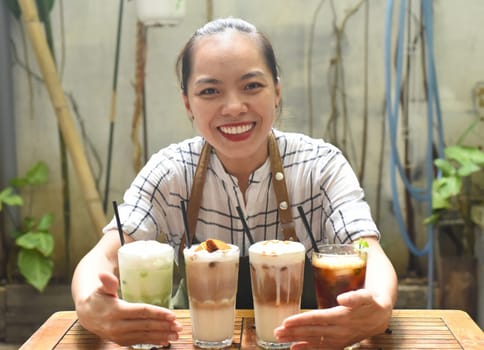 Asian woman waitress prepared beverages to serve in a coffee shop