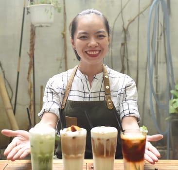 Asian woman waitress prepared beverages to serve in a coffee shop