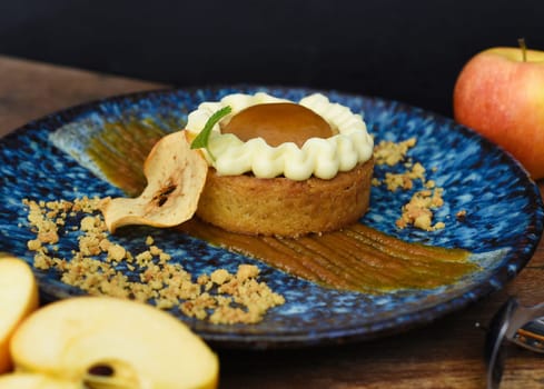 Apple tart with fresh apples on wooden table