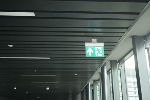 Green exit sign with an arrow, guiding towards emergency exit.