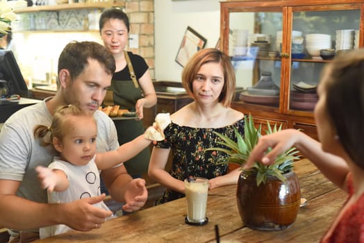 Young people communicate with each other in cafe