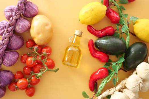 Fresh vegetables including tomatoes, peppers, and lemons with olive oil.