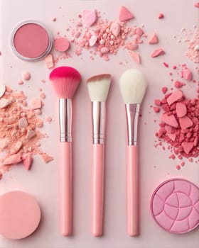A beautiful flat lay featuring three pink makeup brushes, blush powder, and crushed pink powder on soft pink background, perfect for cosmetics, beauty, and makeup artistry.