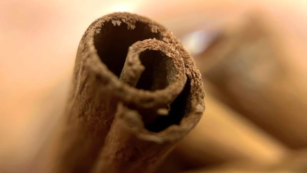 Close-up macro shot of cinnamon sticks showing rich texture and warm brown color.A detailed macro photograph of cinnamon sticks, highlighting their rough texture and curled edges. Perfect for culinary, spice, and aromatic themes.