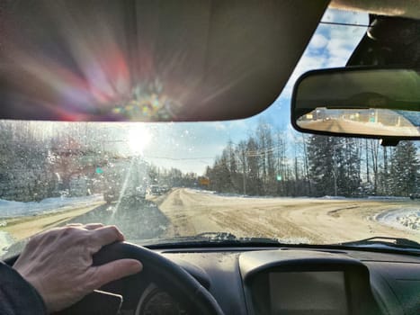 Winter Driving on a winter Snow-Lined Road Under Clear blue Sky. Drivers perspective on a snowy road with one car ahead