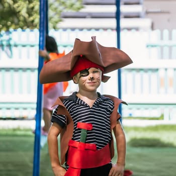 Boy Cat Pirate costume. Halloween party in kindergarten. Aqua makeup painted kids face. Bright festive.