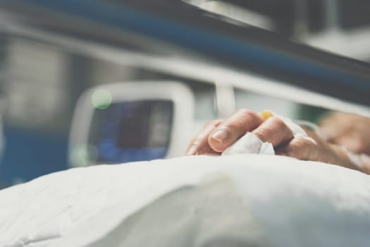 Patient in the hospital with saline intravenous on a elderly patient hand