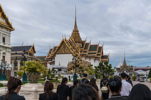 Thai mourners wearing black color waiting in The Grand Palace to pay tribute and respect to their beloved Rama 9 Thai King Bhumibol Adulyadej
