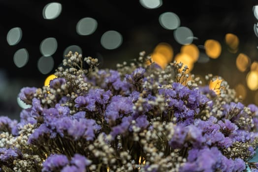 Dried flowers with statice flower in bouquet purple and yellow color use for decoration or congrats with lights bokeh background in flower shop