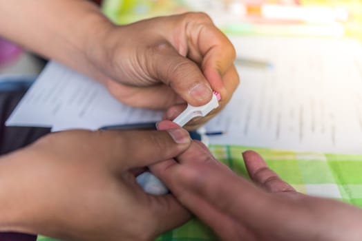 Thai woman health check by measure blood sugar levels every year by the Ministry of Health.