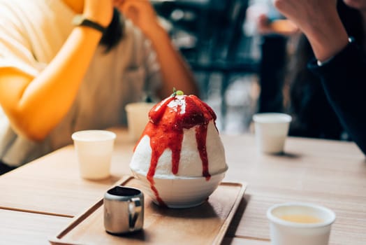 Bingsu or Bingsoo (Patbingsu) is a popular Korean shaved ice dessert with sweet toppings that may include chopped fruit, condensed milk, fruit syrup, and varieties with ingredients