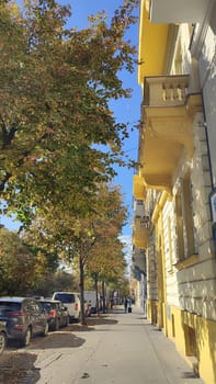October 15 2024 Prague Czech Republic Europe Sunny autumn street architecture trees building yellow wall cars. High quality photo editorial