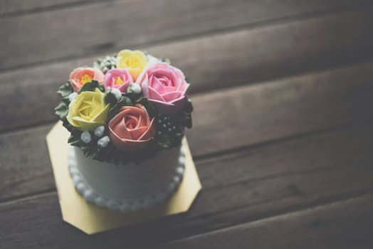 Cake cream is a form of sweet dessert that is typically baked. ingredients are flour, sugar, eggs, butter or oil or margarine, a liquid, and leavening agents on wooden table