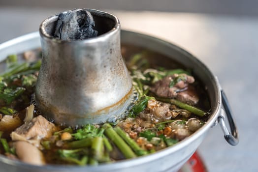 Braised beef clear with meat tendon soup stew (Ekaehla meat) with vegetable in hot pot for sale at Thai street food market or restaurant in Thailand