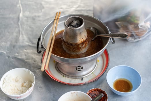Braised beef clear with meat tendon soup stew (Ekaehla meat) with vegetable in hot pot for sale at Thai street food market or restaurant in Thailand