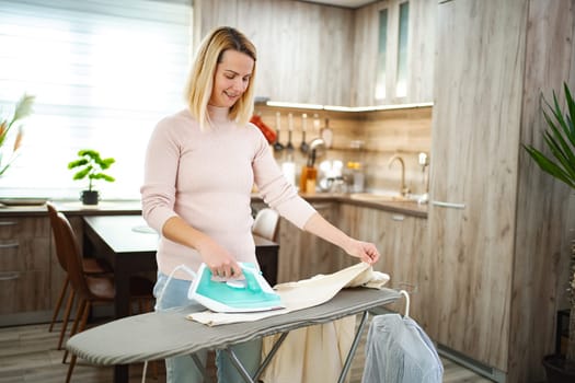 Bright and cheerful atmosphere as a woman diligently smooths clothes.