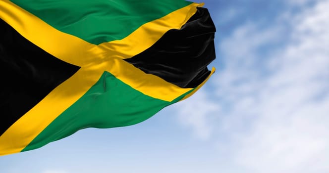 Close-up of Jamaica national flag waving. Gold saltire dividing it into four sections: two green and two black. 3d illustration render. Fluttering fabric. textured background
