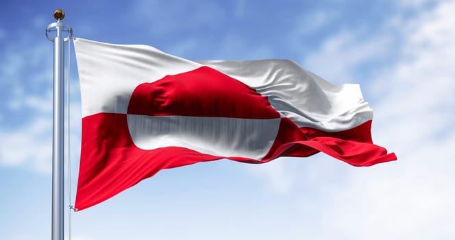 The flag of Greenland waving in the wind on a clear day. Greenland is the world's largest island, and one of the three constituent countries that form the Kingdom of Denmark,