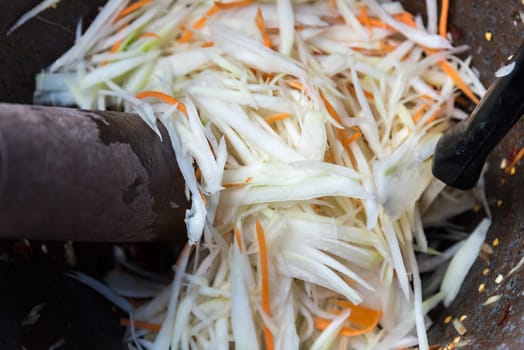 Papaya salad or Papaya Pok Pok (Som tum) for sale at Thai street food market or restaurant in Thailand