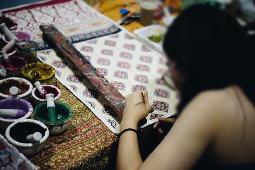 Thai artist drawing a striped Thai art for making Thai silk design by Ayutthaya traditional contemporary fashion