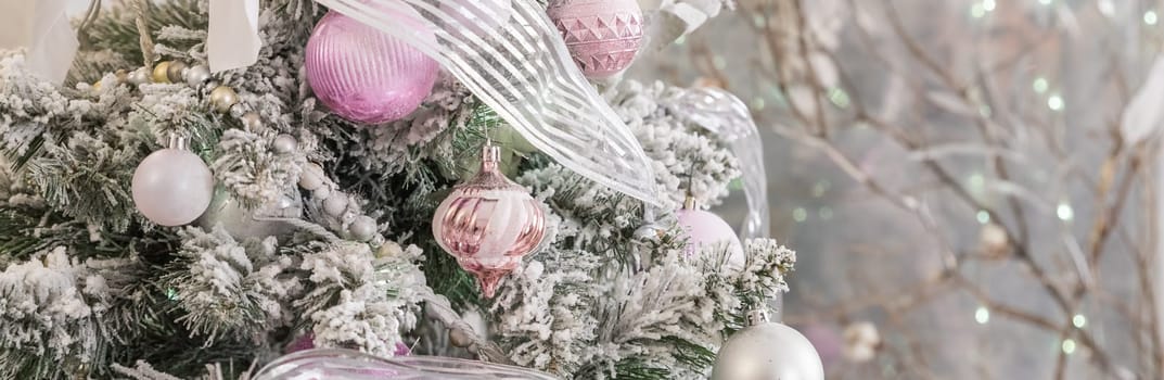 pink and white christmas tree decoration. Green and White Christmas tree with pink toys, new year winter gifts decor.