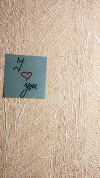 Text I love you on post it. Writing on colorful sticky note. Bucharest, Romania, 2020.