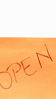 Open handwriting text close up isolated on orange paper with copy space.