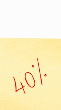 40% handwriting text close up isolated on orange paper with copy space. Writing text on memo post reminder.