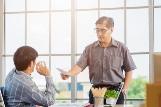 Asian businessman anti bribery and corruption he rejecting money in white envelope offered by partner. Business man sending resignation letter to employee the business downturn to laid off at office