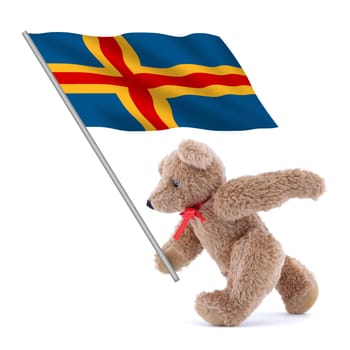 An Aland Islands flag being carried by a cute teddy bear