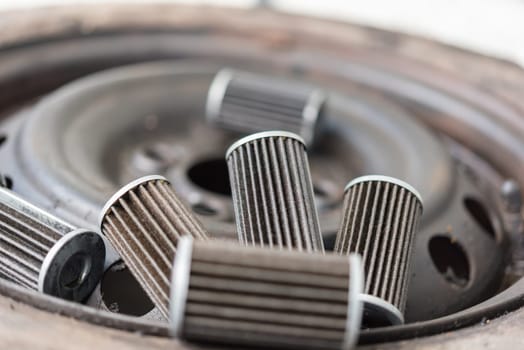 Old lubricant engine oil filter at car garage after changing the new oil filter for repair or maintenance in a car engine