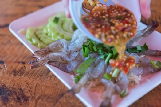 Shrimp in fish sauce premium grade is a seafood display for sale at Thai street food market or restaurant in Bangkok Thailand