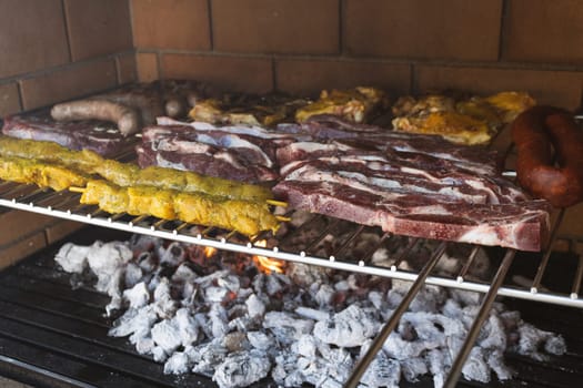 A tantalizing arrangement of various meats grilling over hot coals, showcasing the art of barbecue, perfect for food enthusiasts and culinary lovers alike.